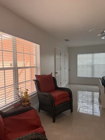 a bedroom with a bed and a couch next to a window