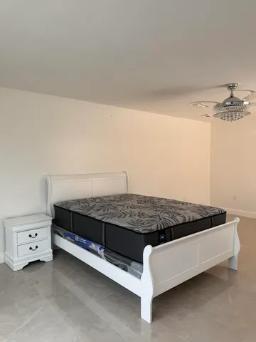 a bedroom with a bed and a night stand