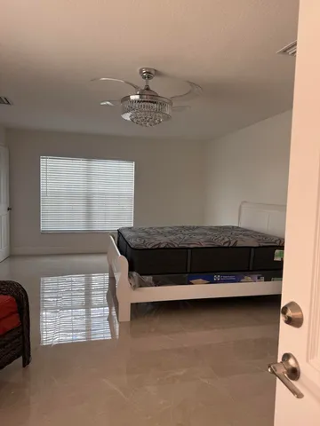 a view of a room with furniture and a window