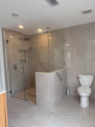 a bathroom with a shower and toilet