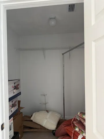 a bedroom with a bed and cabinets