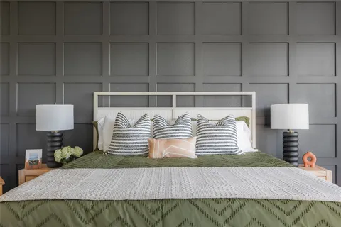 a bedroom with a bed and lamp