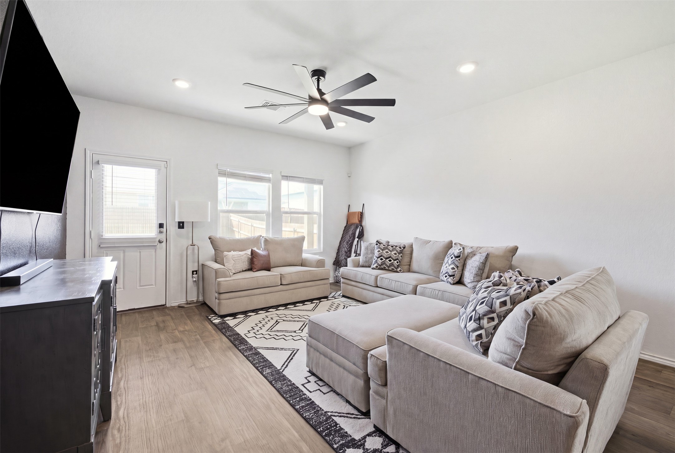 15000 Bajada Rd Manor Manor, TX 78653 - Photo 13 of 31 Recessed lighting and a modern ceiling fan illuminate this comfortable living space with durable wood flooring.