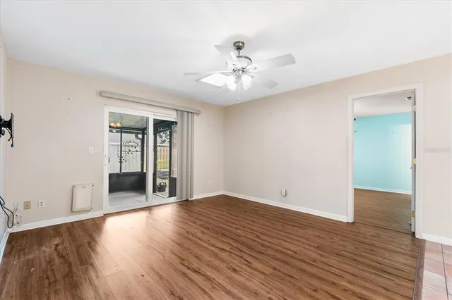 wooden floor in an empty room with a window