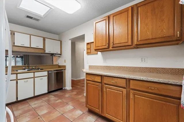 a kitchen with granite countertop cabinets stainless steel appliances and a sink