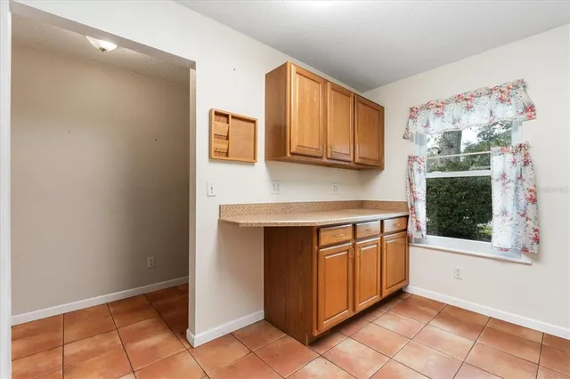a kitchen with granite countertop a stove a microwave and a sink