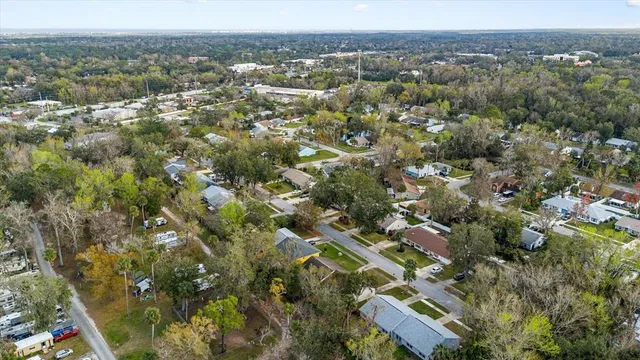 an aerial view of residential houses with outdoor space and river