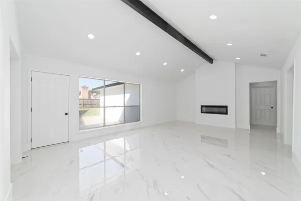 an empty room with white wall and hall
