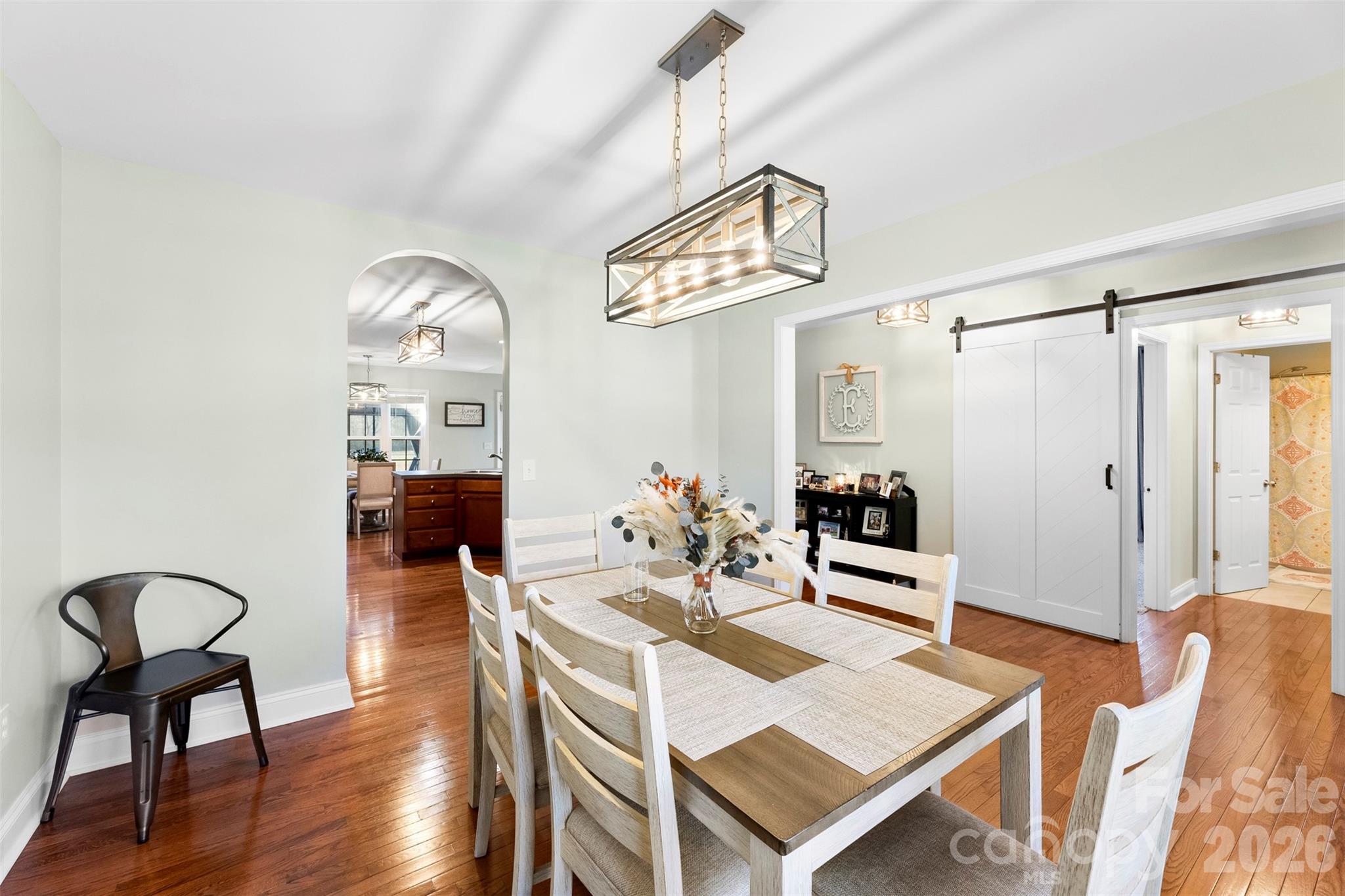 1298 Timber Spring Lane Salisbury, NC 28147 - Photo 16 of 34 a living room with furniture a chandelier and kitchen view