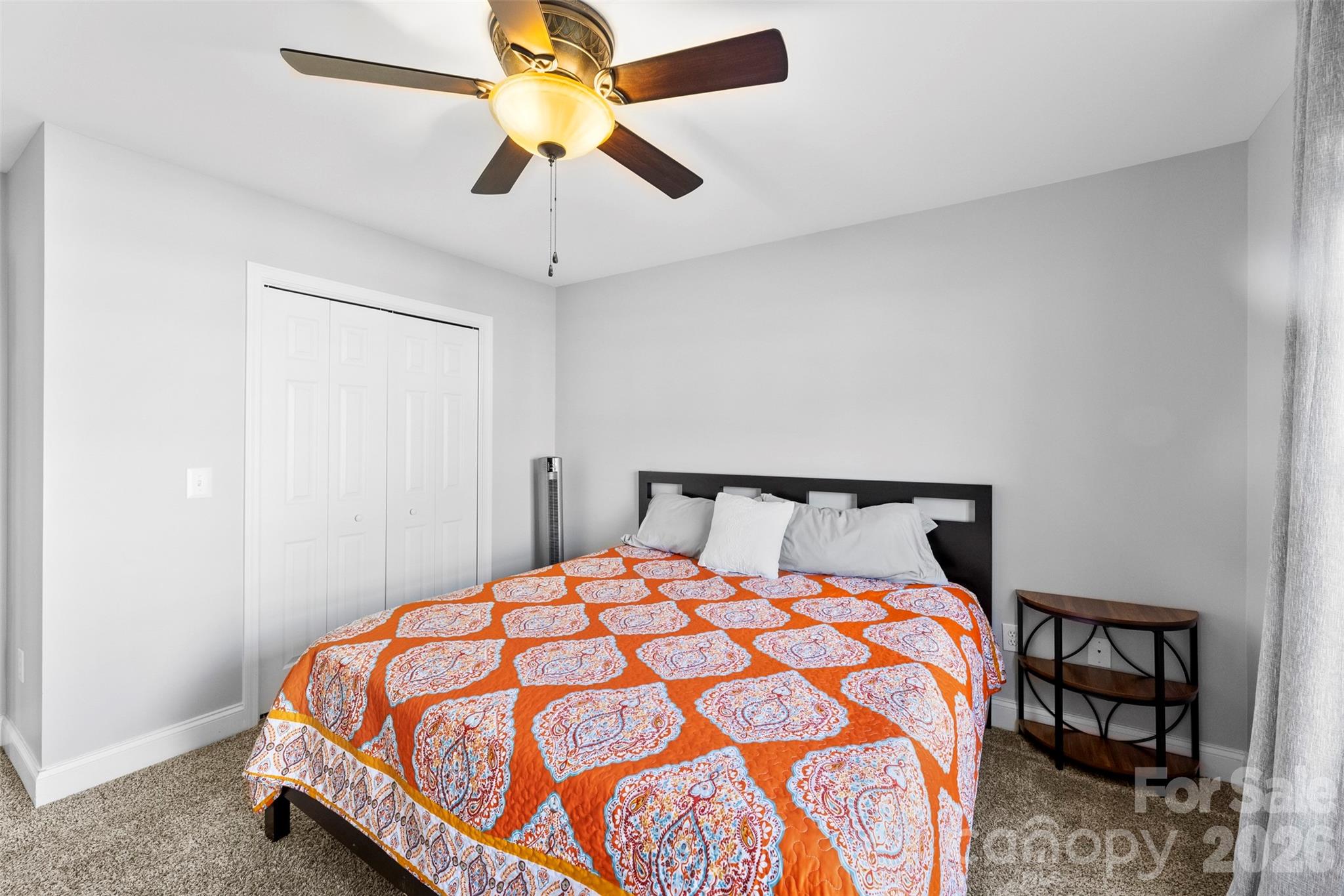 1298 Timber Spring Lane Salisbury, NC 28147 - Photo 21 of 34 a bed sitting in a bedroom and a chandelier