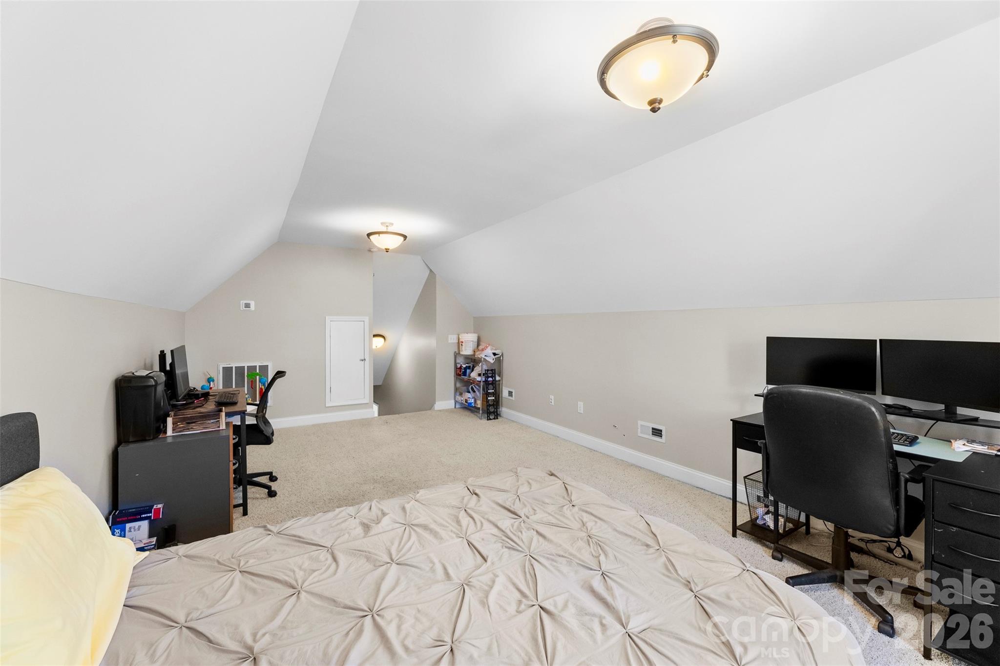 1298 Timber Spring Lane Salisbury, NC 28147 - Photo 27 of 34 a bedroom with bed and a chandelier