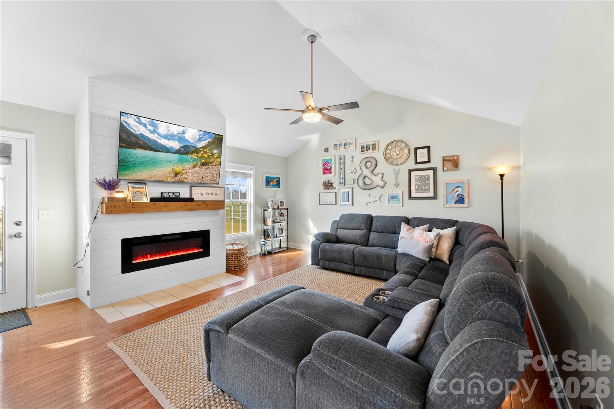 1298 Timber Spring Lane Salisbury, NC 28147 - Photo 5 of 34 a living room with furniture a fireplace and a chandelier