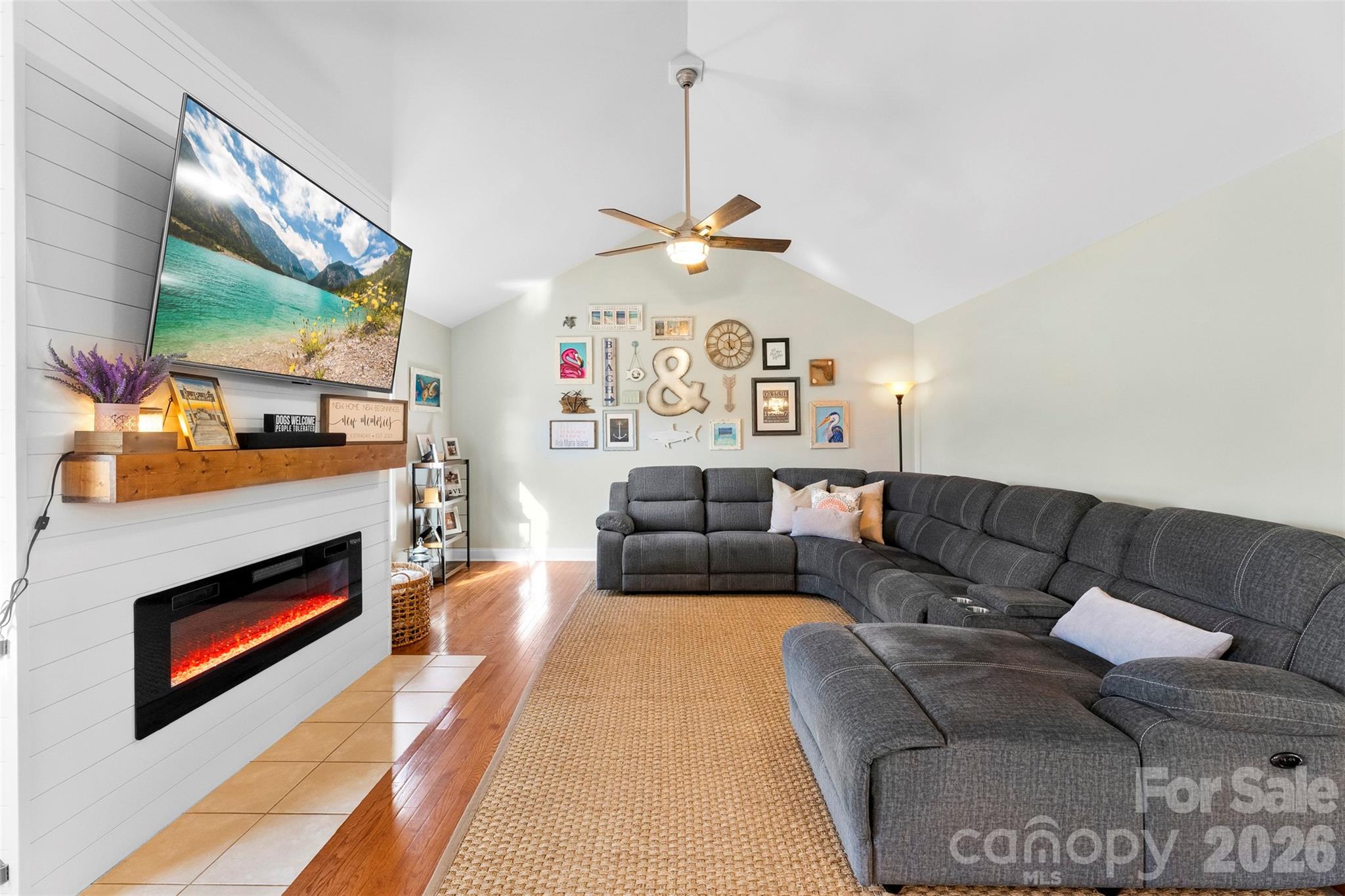 1298 Timber Spring Lane Salisbury, NC 28147 - Photo 6 of 34 a living room with furniture a flat screen tv and a fireplace