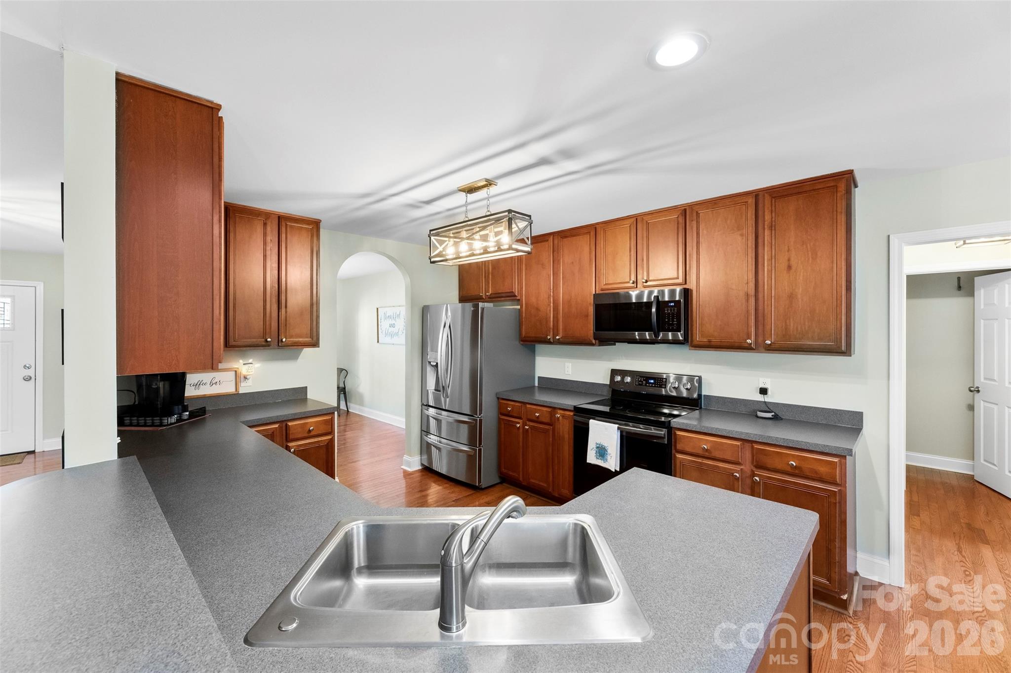 1298 Timber Spring Lane Salisbury, NC 28147 - Photo 10 of 34 a kitchen with stainless steel appliances granite countertop a refrigerator stove microwave and sink