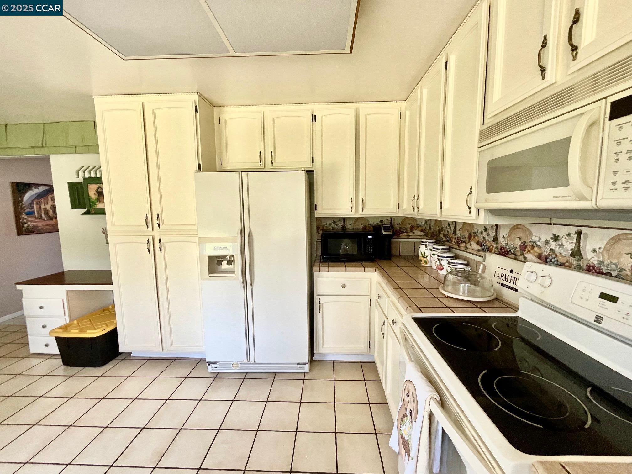 403 Gerald Court Benicia, CA 94510 - Photo 14 of 59 a kitchen with a sink stove and refrigerator