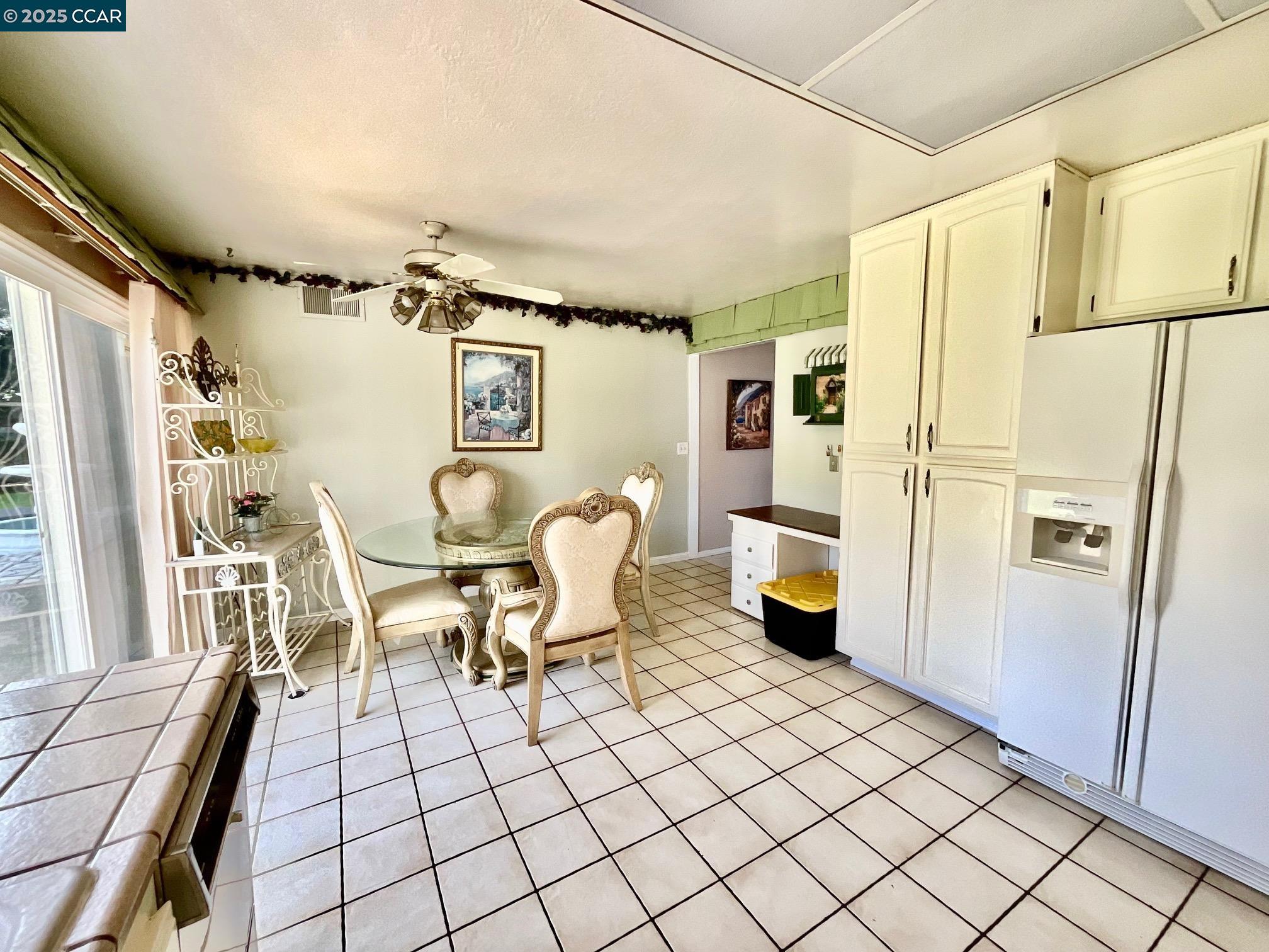 403 Gerald Court Benicia, CA 94510 - Photo 15 of 59 a living room with furniture and a refrigerator