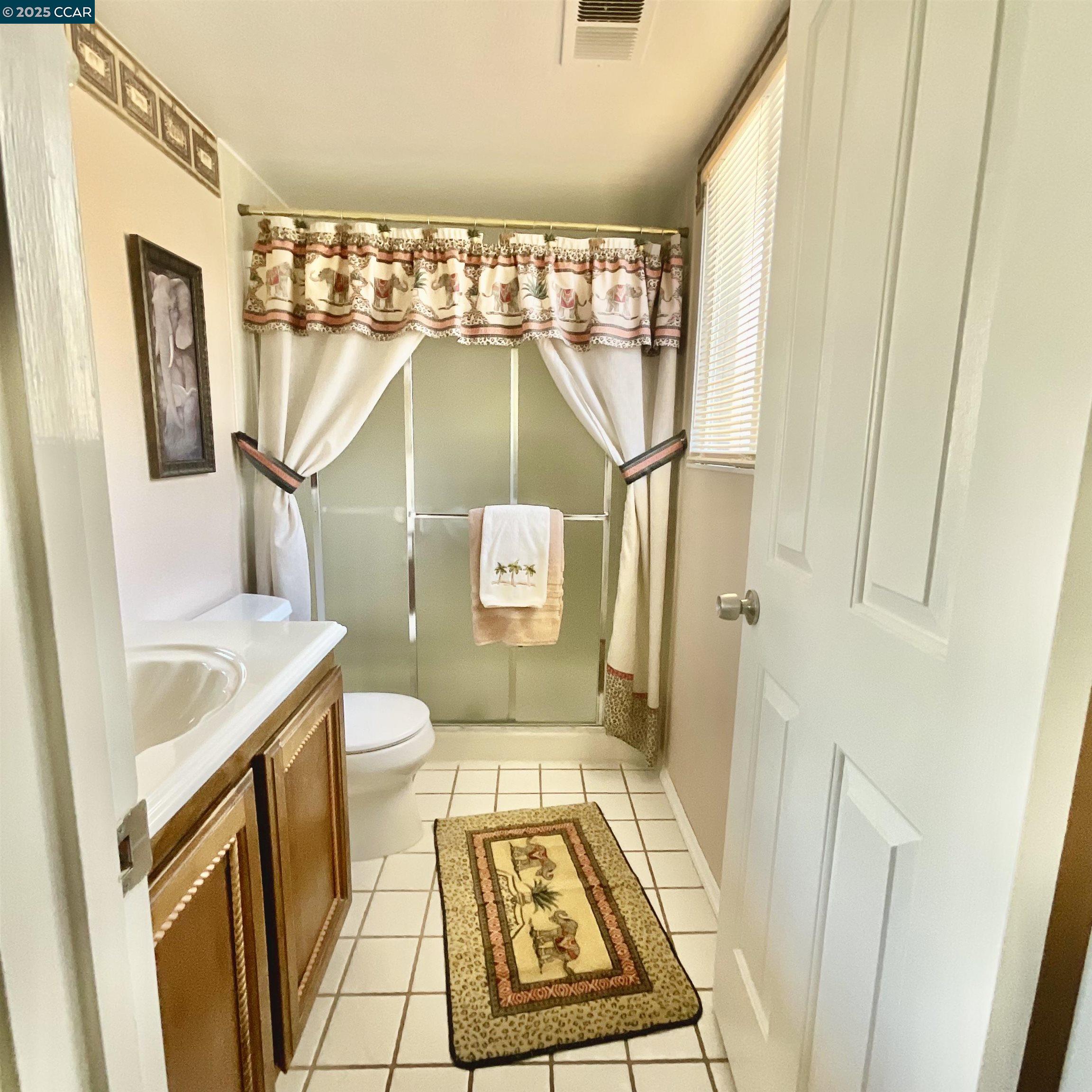 403 Gerald Court Benicia, CA 94510 - Photo 21 of 59 a bathroom with a sink toilet and shower