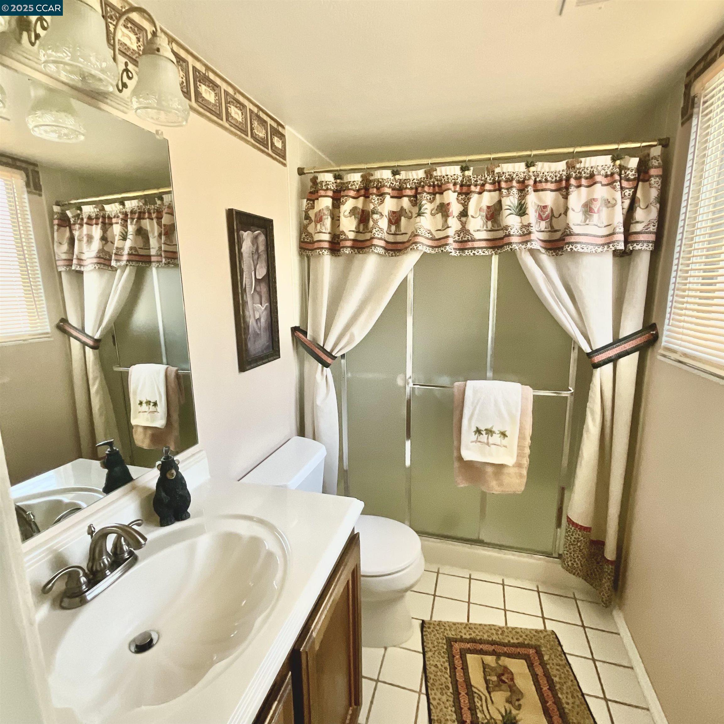 403 Gerald Court Benicia, CA 94510 - Photo 22 of 59 a bathroom with a sink and mirror with bathtub