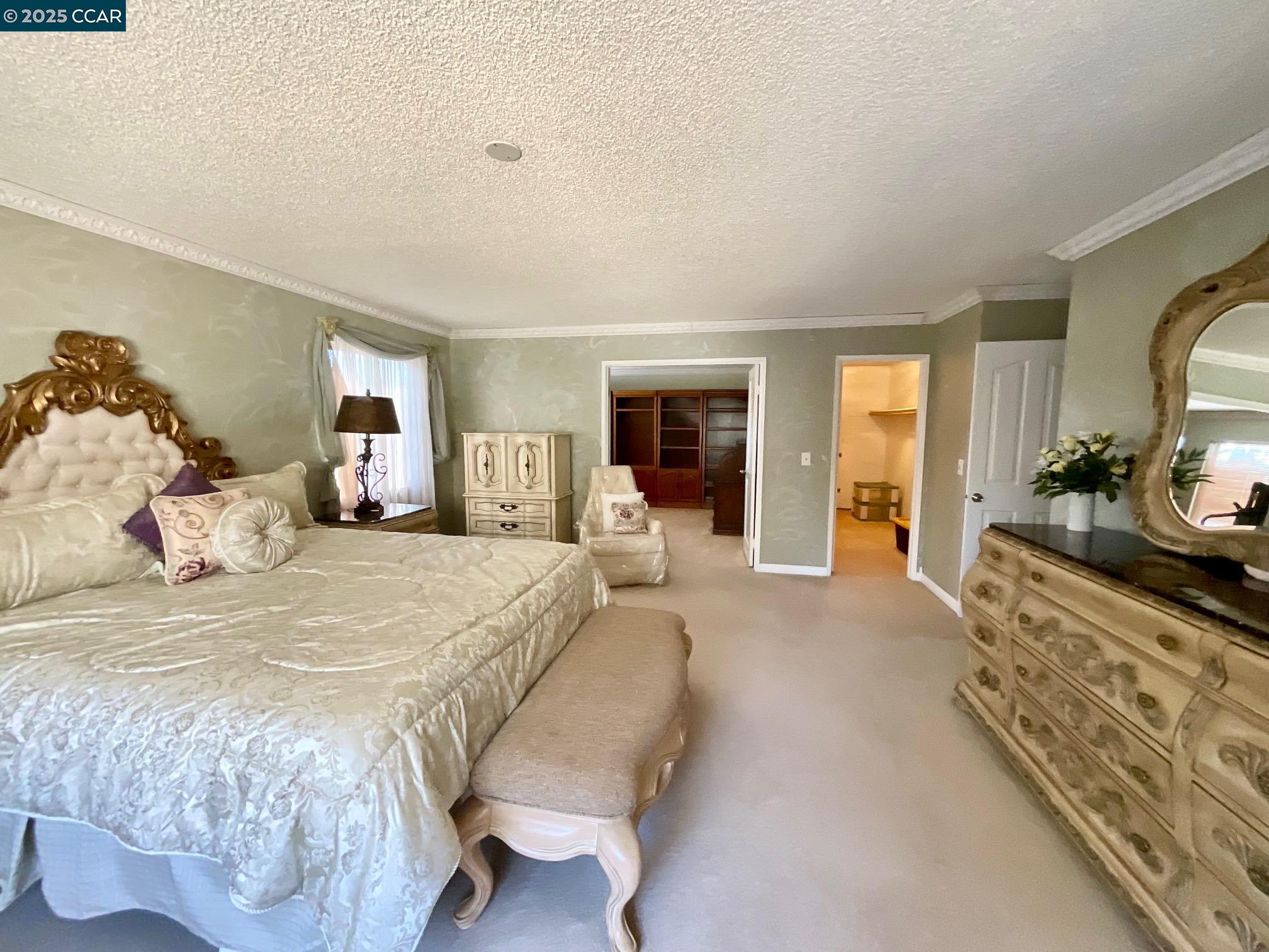 403 Gerald Court Benicia, CA 94510 - Photo 39 of 59 a spacious bedroom with a bed a mirror and a flat tv screen on dresser