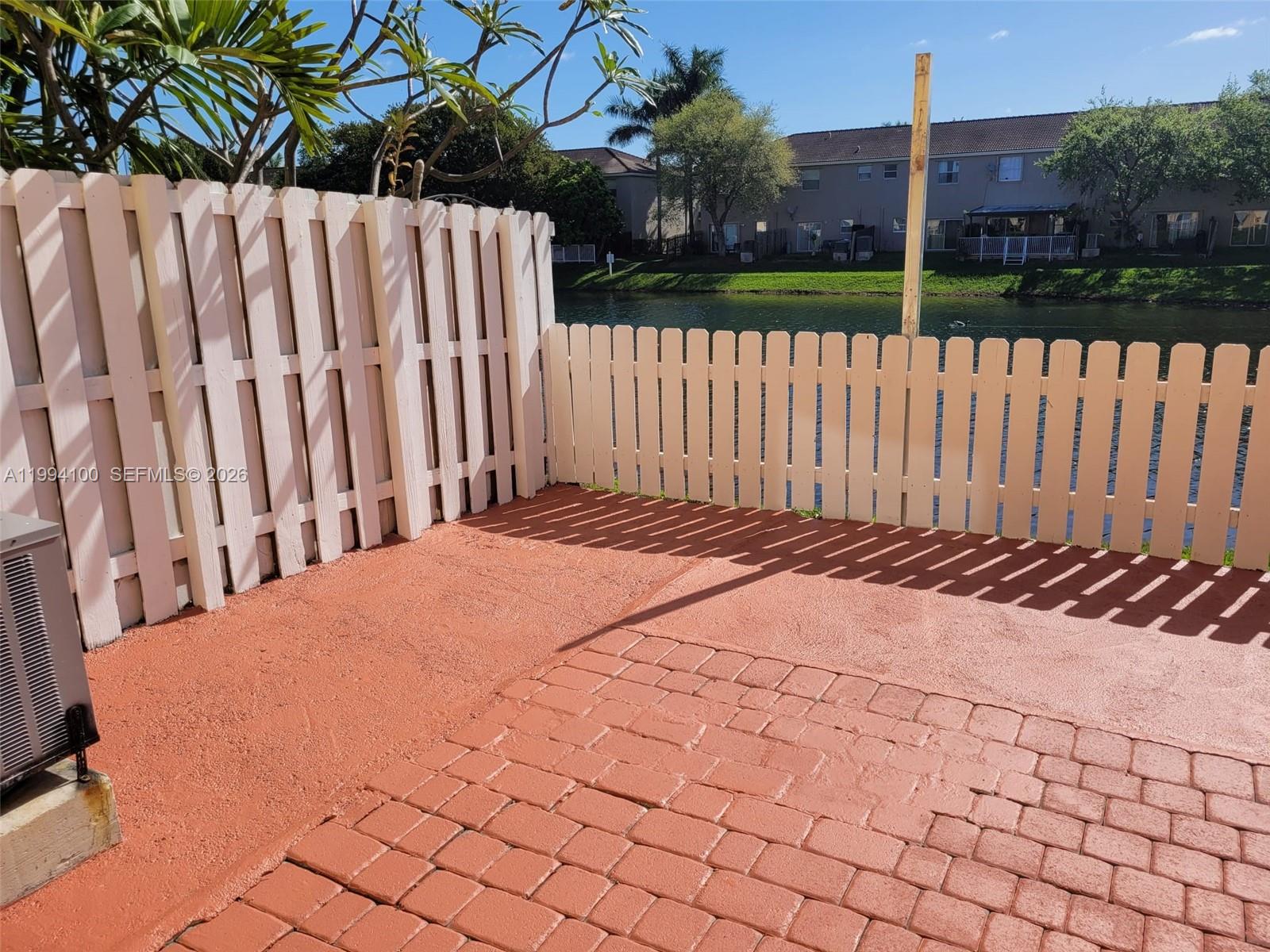 9001 Southwest 227th Street, Unit 7 Cutler Bay, FL 33190 - Photo 11 of 13 a view of a backyard with a fence