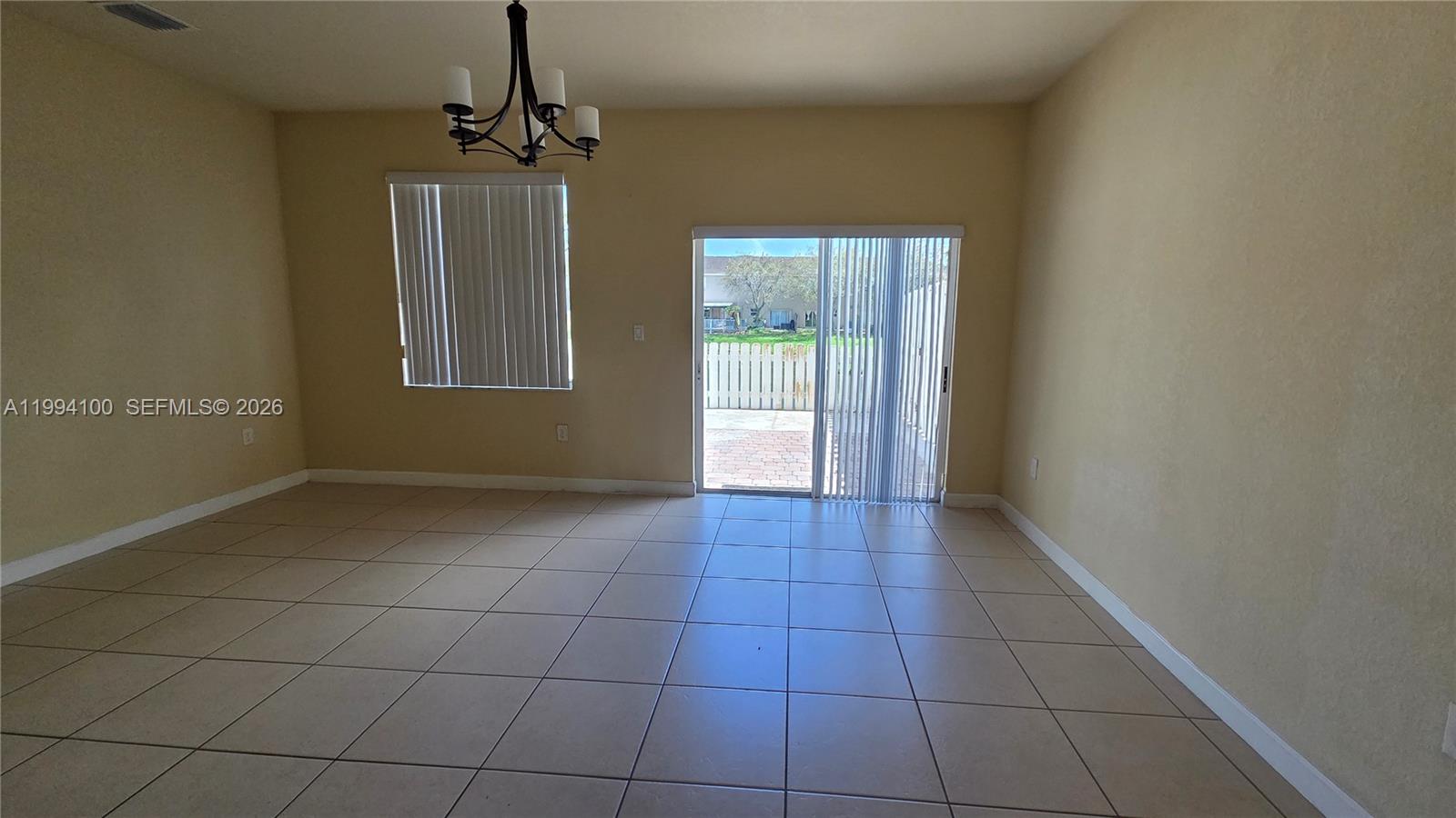 9001 Southwest 227th Street, Unit 7 Cutler Bay, FL 33190 - Photo 3 of 13 a view of an empty room with a window