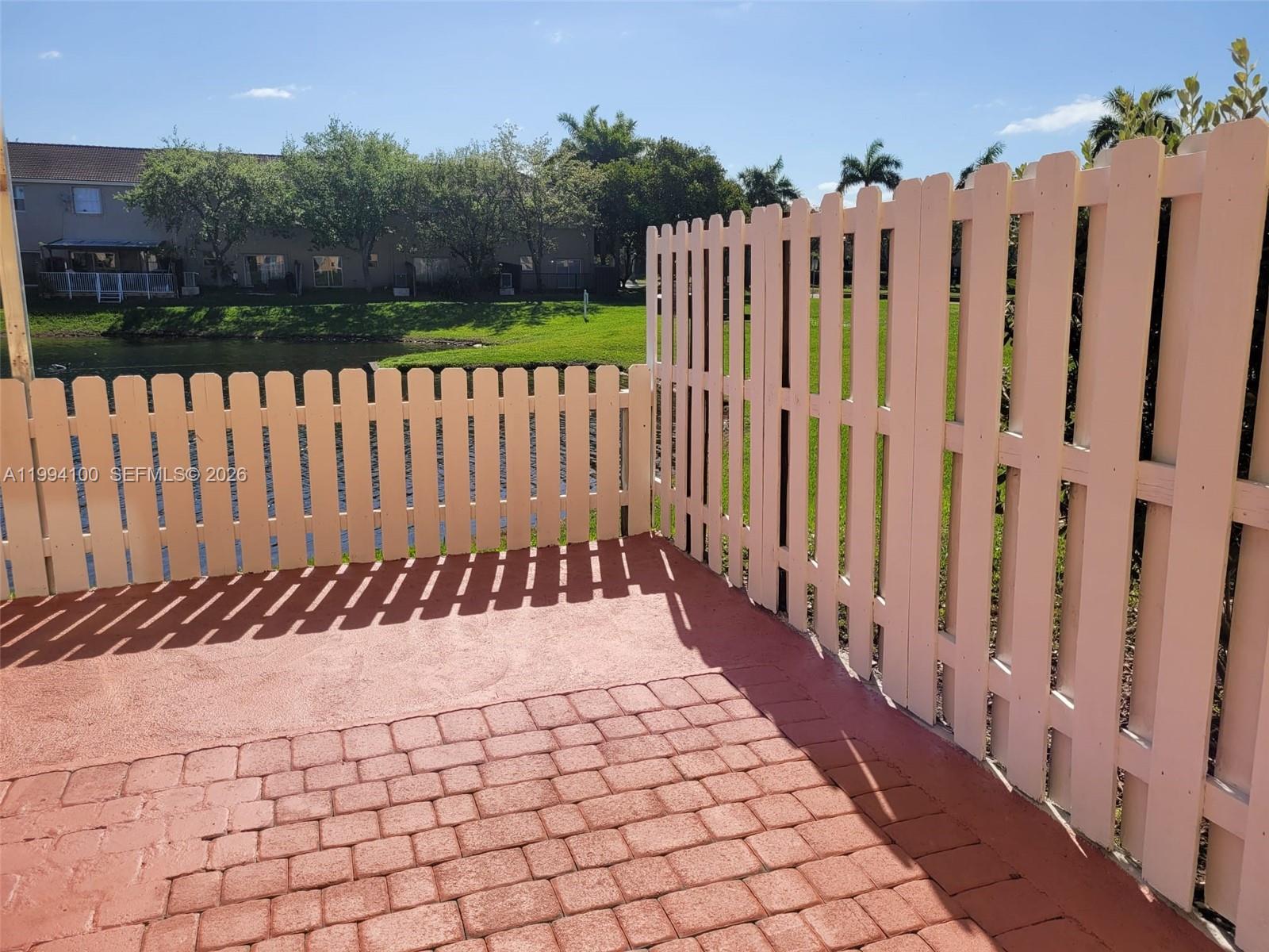 9001 Southwest 227th Street, Unit 7 Cutler Bay, FL 33190 - Photo 10 of 13 a view of a wooden fence