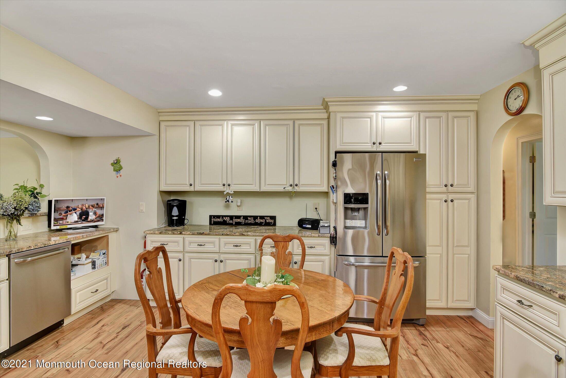 1995 Campbell Road Belmar, NJ 07719 - Photo 15 of 46 a kitchen with stainless steel appliances a refrigerator a stove a sink dishwasher and white cabinets with wooden floor