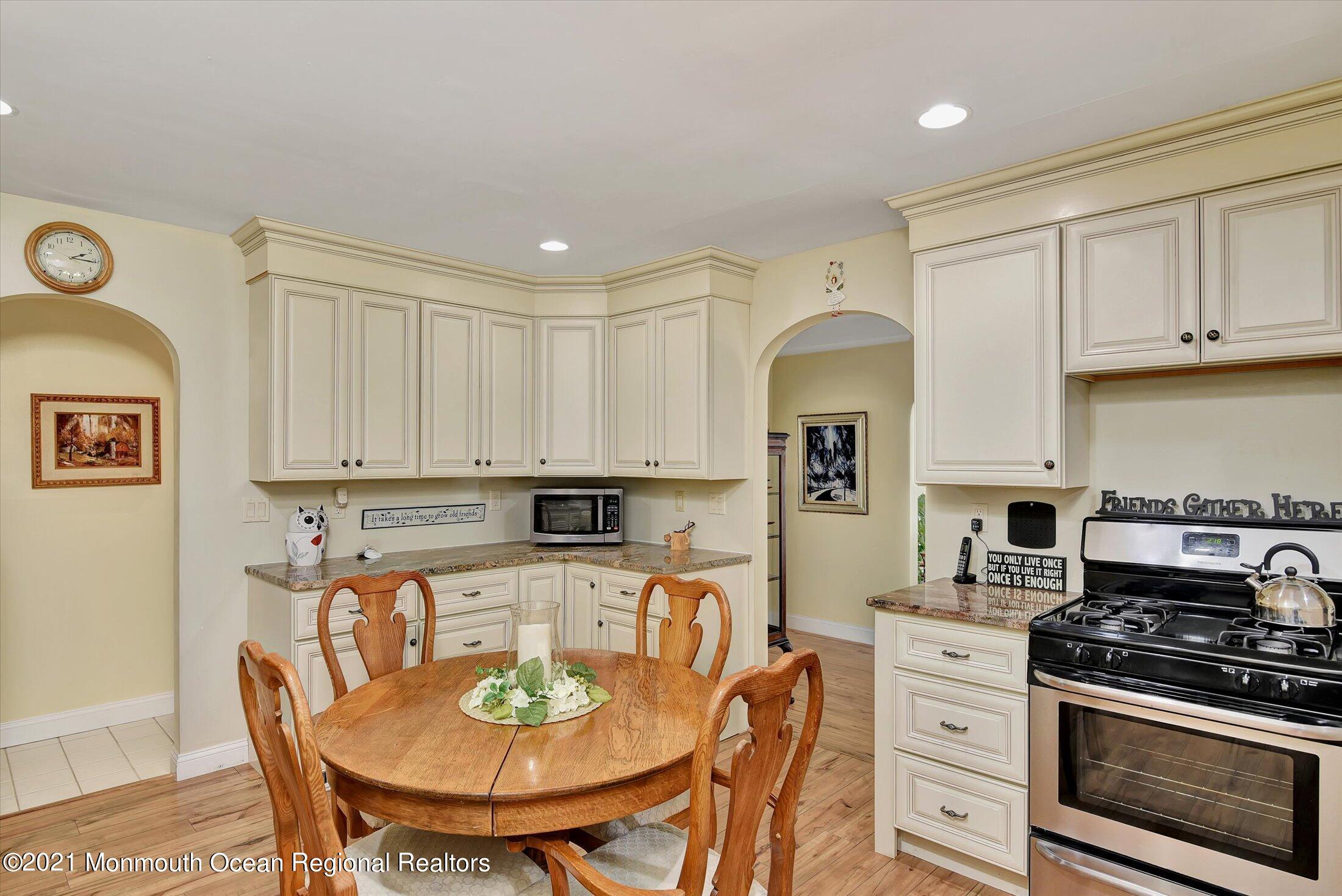 1995 Campbell Road Belmar, NJ 07719 - Photo 16 of 46 a kitchen with stainless steel appliances granite countertop a stove a sink dishwasher and white cabinets with wooden floor