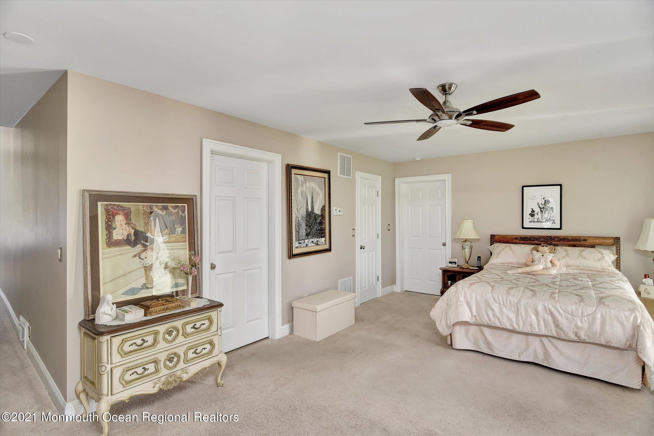 1995 Campbell Road Belmar, NJ 07719 - Photo 17 of 46 a bedroom with a large bed and a chandelier