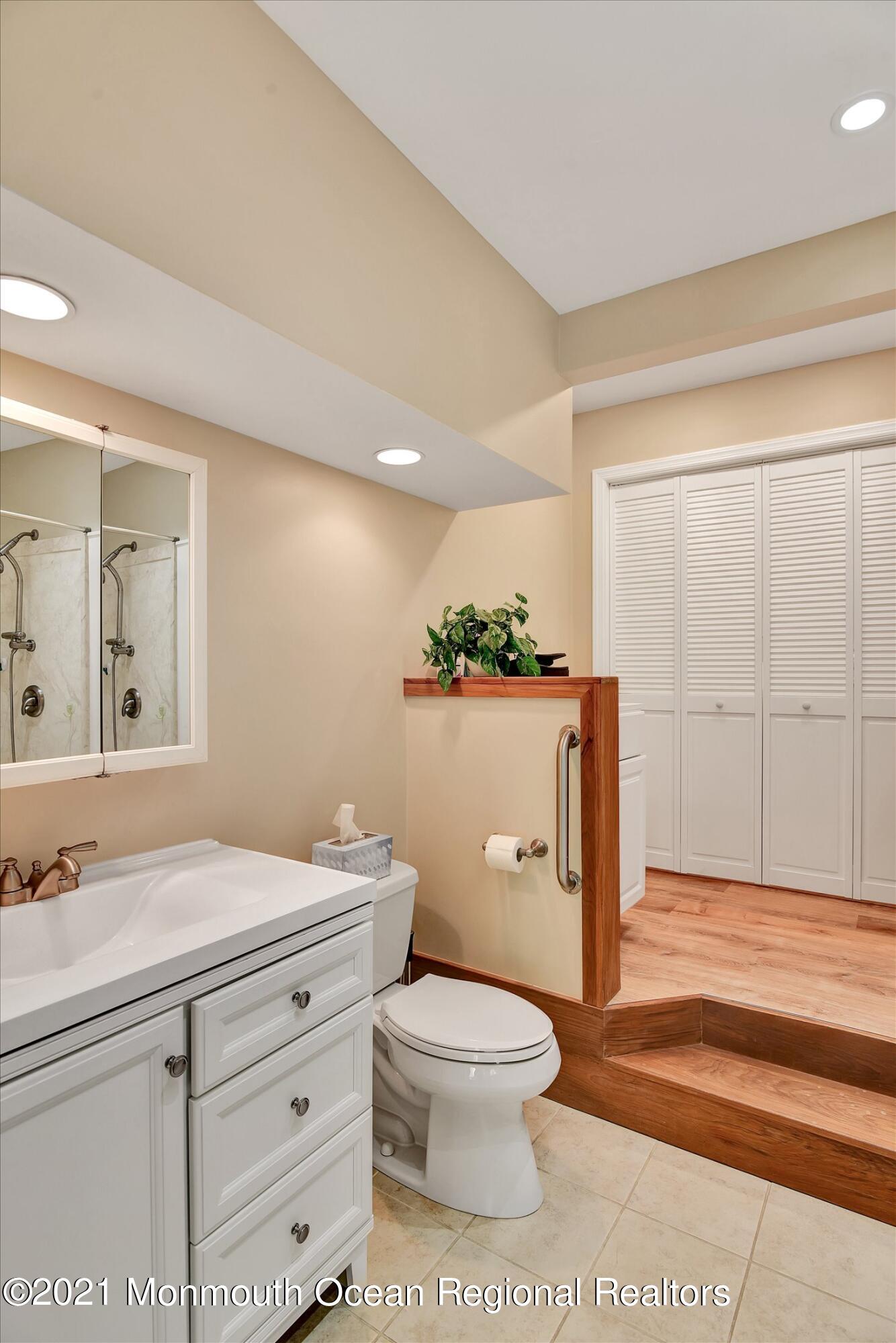 1995 Campbell Road Belmar, NJ 07719 - Photo 20 of 46 a bathroom with a toilet a sink and mirror
