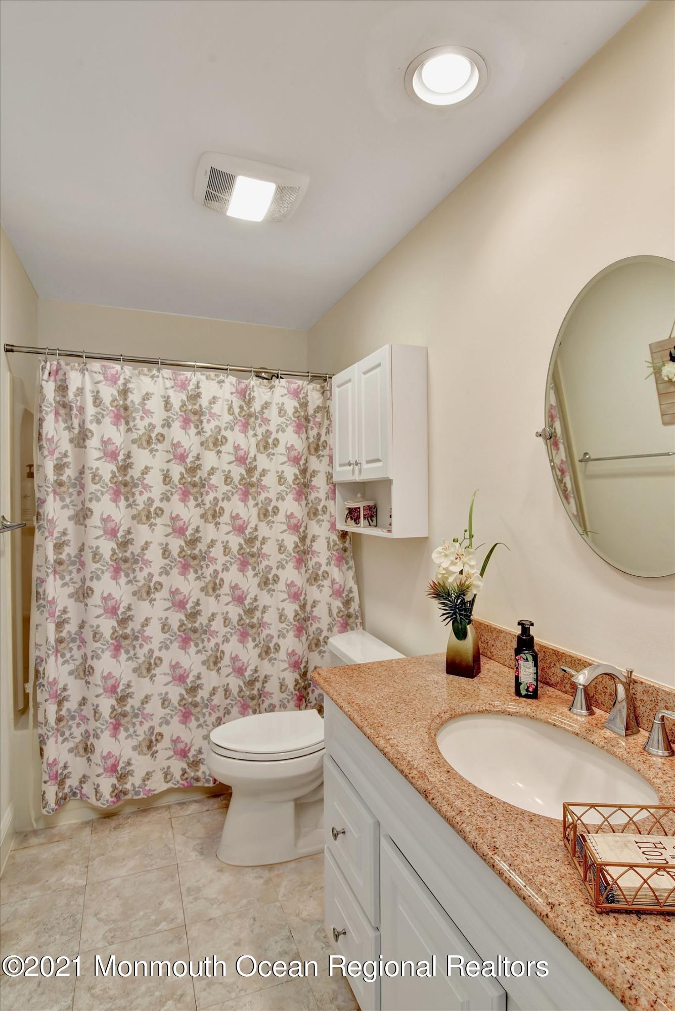 1995 Campbell Road Belmar, NJ 07719 - Photo 24 of 46 a bathroom with a granite countertop sink a toilet and a mirror