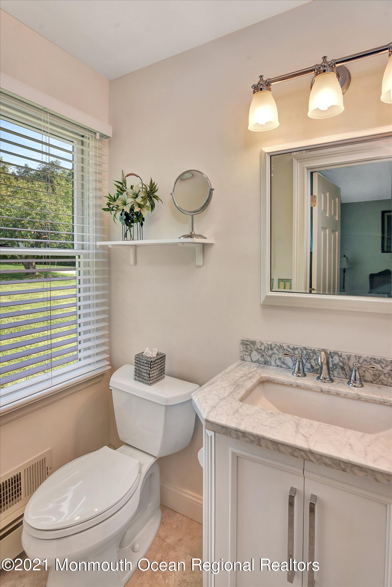 1995 Campbell Road Belmar, NJ 07719 - Photo 26 of 46 a bathroom with a toilet sink and mirror