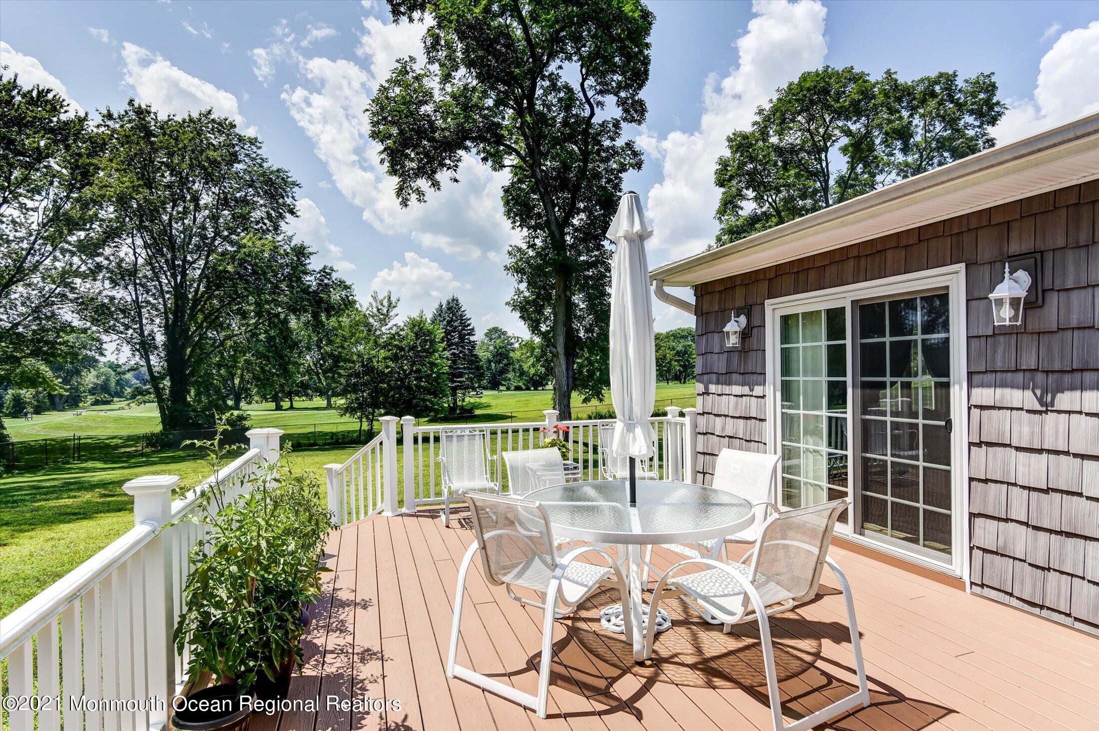 1995 Campbell Road Belmar, NJ 07719 - Photo 32 of 46 a view of a patio with dining table and chairs with a large tree