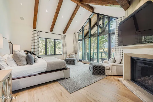 a bedroom with a balcony a bed and a fireplace