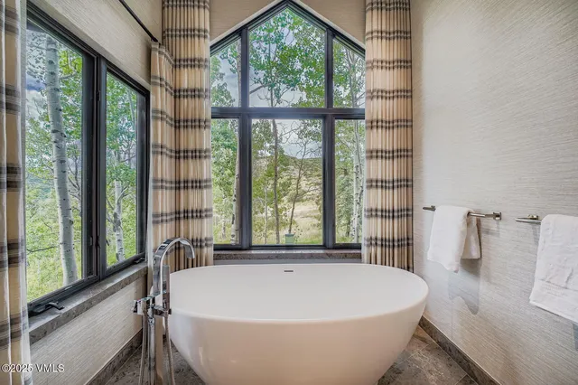 a white bath tub sitting in front of a window