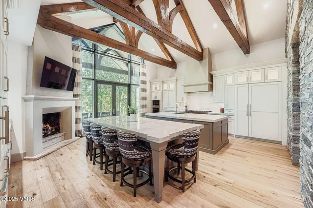 a view of a dining room with furniture wooden floor and a fireplace