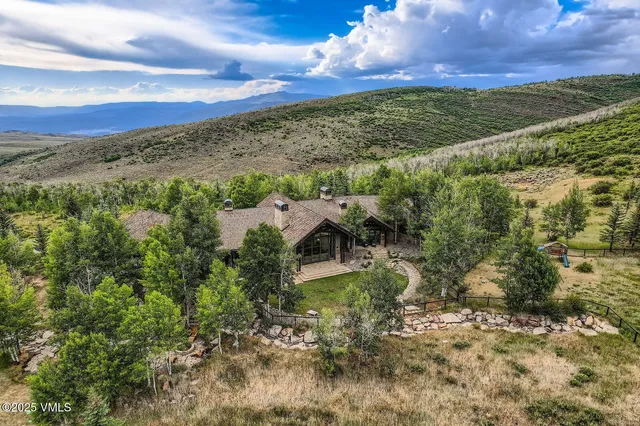 a view of a yard with wooden fence