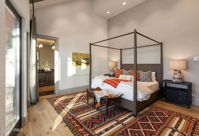 a bedroom with a bed and a chandelier