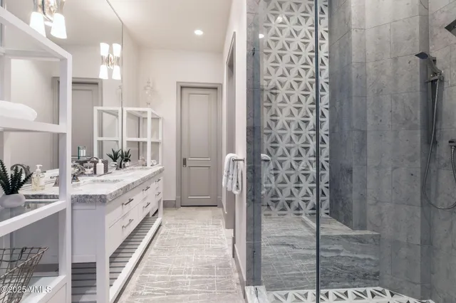 a bathroom with a double vanity sink a toilet a shower and a mirror