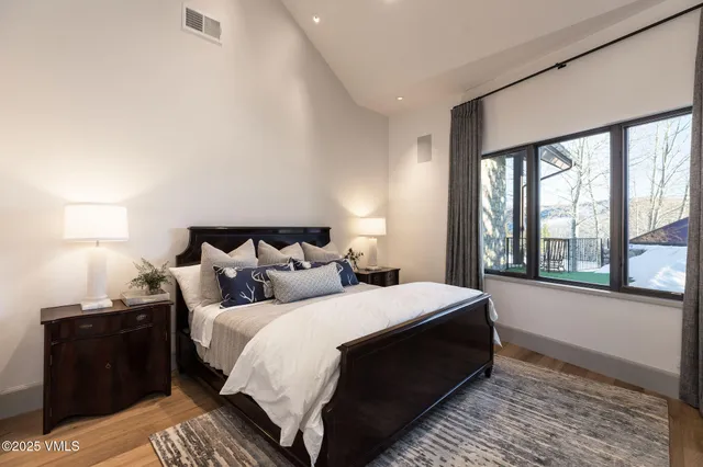 a bedroom with double bed and a window