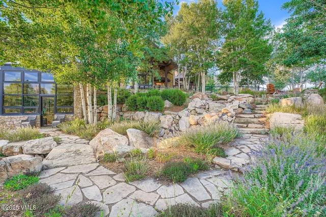 a view of a chairs and table in a backyard