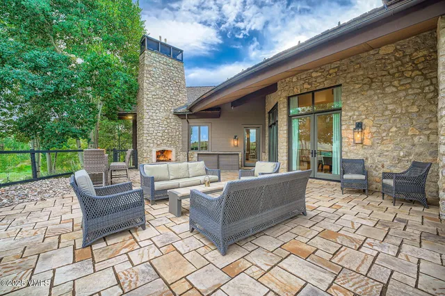 a view of a patio with couches chairs and a wooden floor