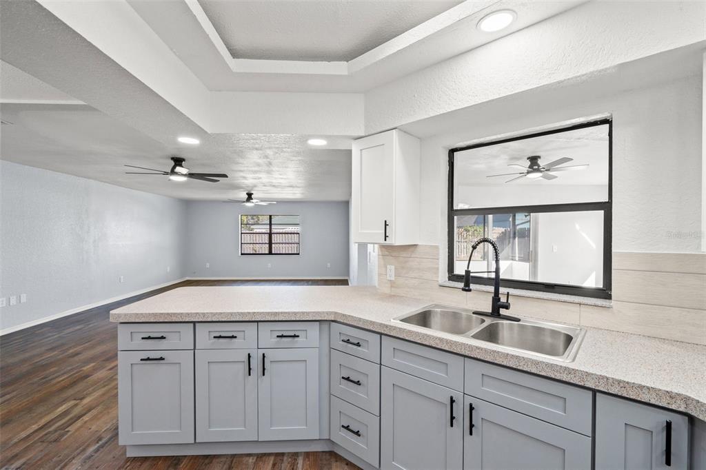 11215 Addison Street Spring Hill, FL 34609 - Photo 13 of 51 a bathroom with a sink and two mirror