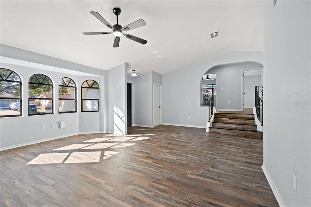 11215 Addison Street Spring Hill, FL 34609 - Photo 17 of 51 a view of an empty room with window and wooden floor