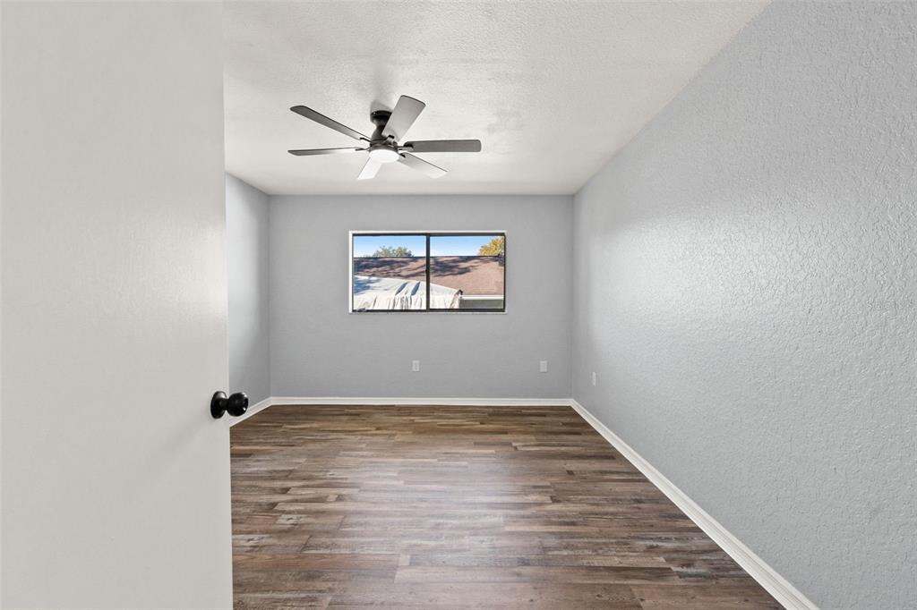 11215 Addison Street Spring Hill, FL 34609 - Photo 19 of 51 a view of empty room with wooden floor