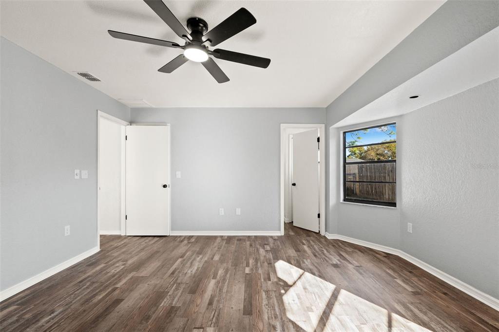 11215 Addison Street Spring Hill, FL 34609 - Photo 23 of 51 a view of empty room with wooden floor