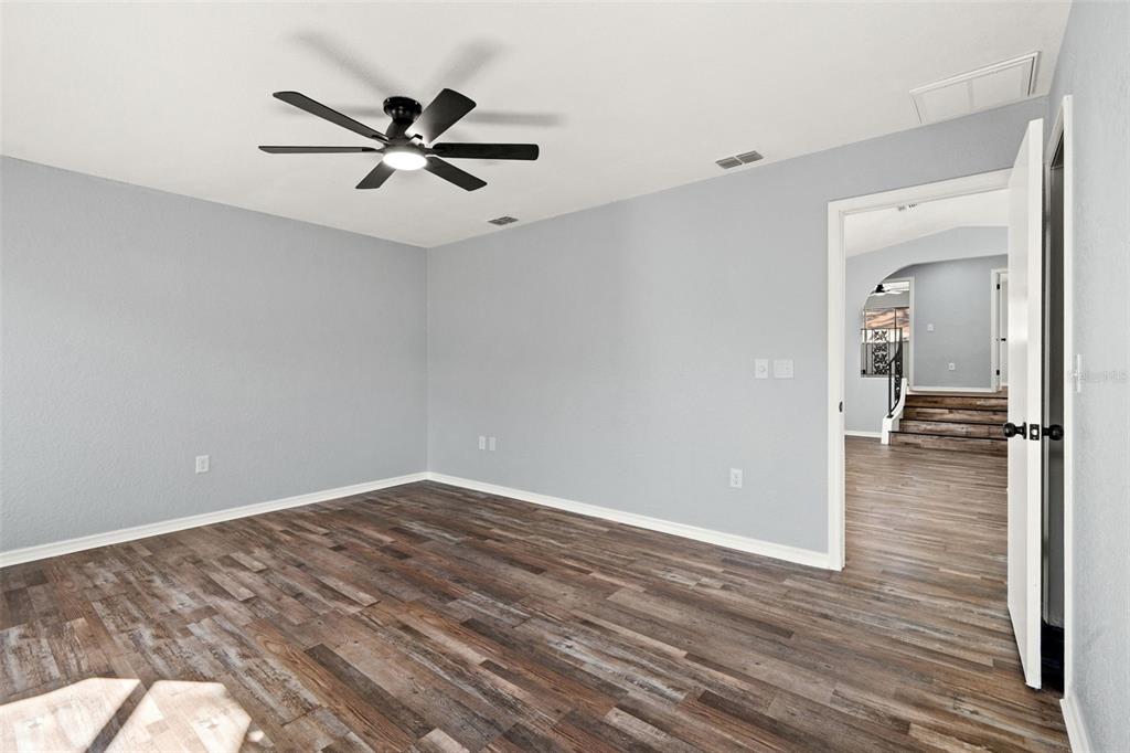 11215 Addison Street Spring Hill, FL 34609 - Photo 24 of 51 wooden floor in an empty room with a window