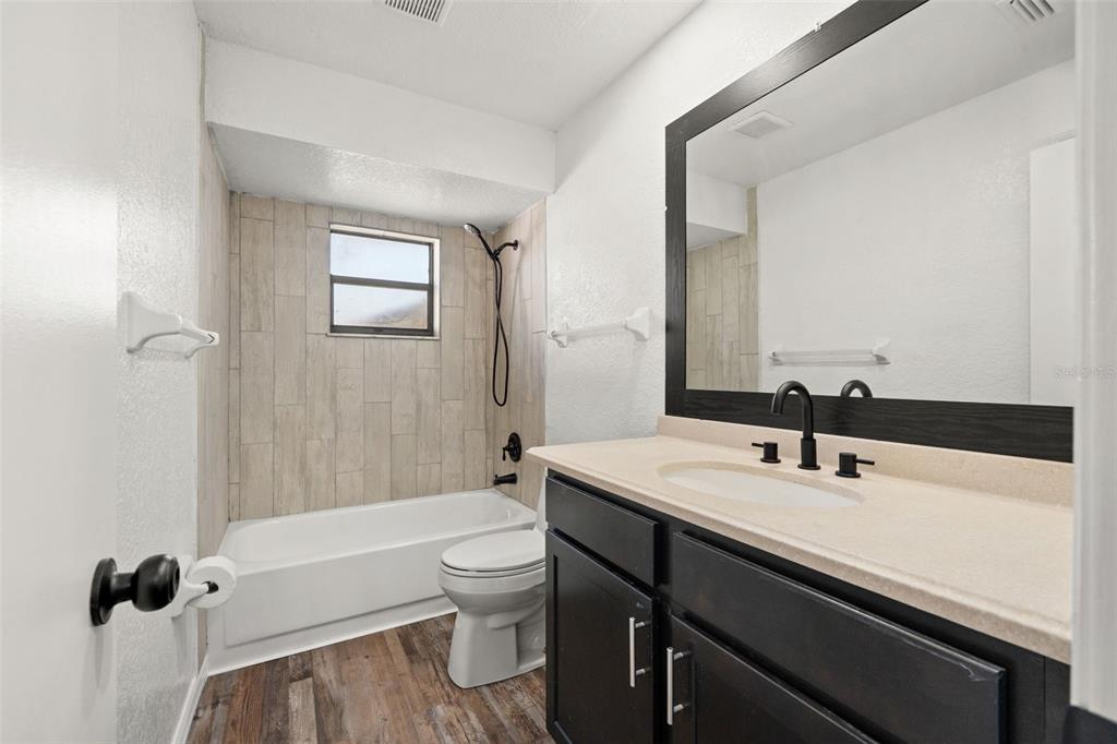 11215 Addison Street Spring Hill, FL 34609 - Photo 28 of 51 a bathroom with a sink a toilet and shower