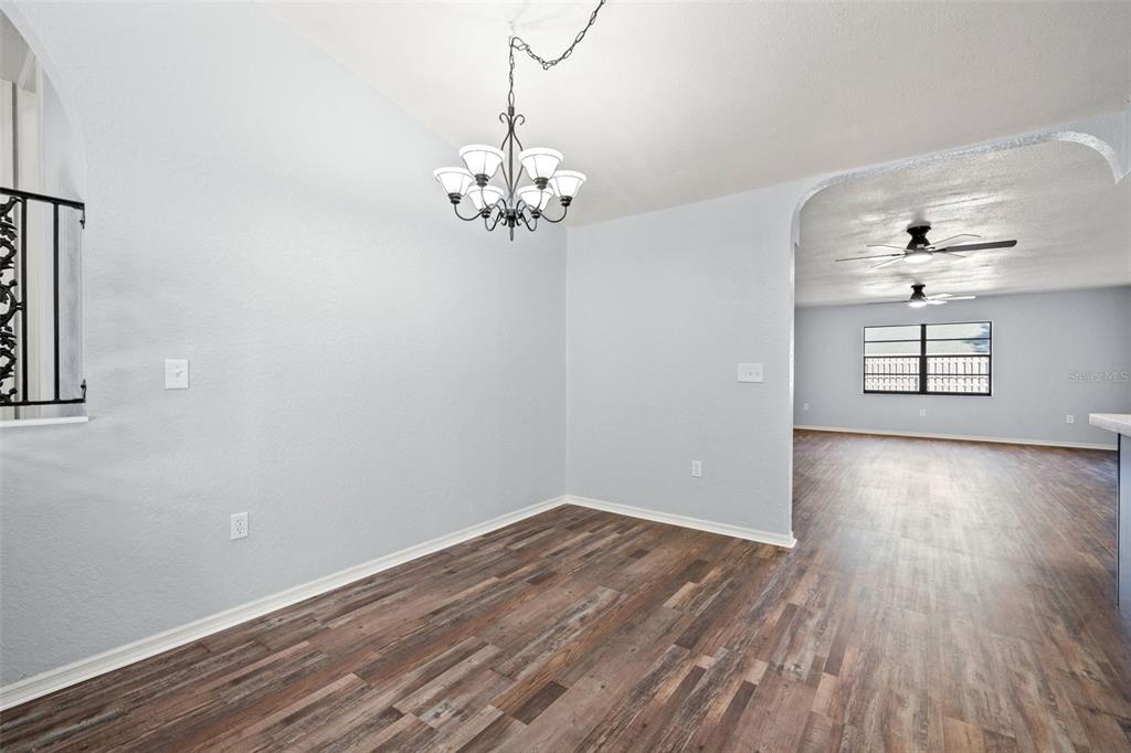 11215 Addison Street Spring Hill, FL 34609 - Photo 29 of 51 wooden floor in an empty room with a window