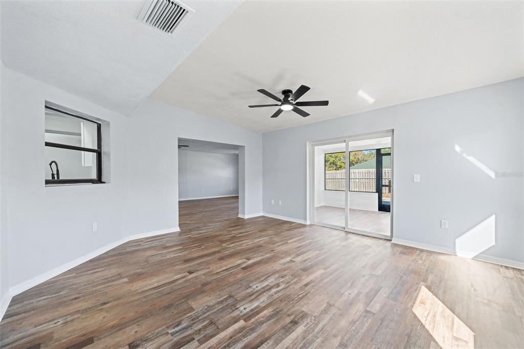 11215 Addison Street Spring Hill, FL 34609 - Photo 31 of 51 a view of empty room with wooden floor and fan